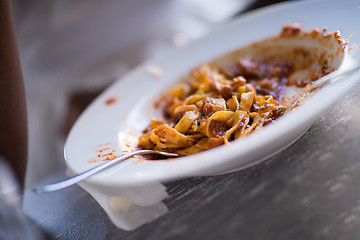 Image showing a young African American woman eating pasta