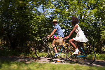 Image showing Young multiethnic couple having a bike ride in nature