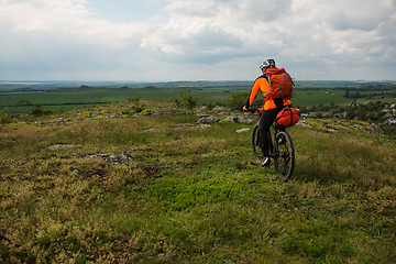 Image showing Young man is riding bicycle outside. Healthy Lifestyle.