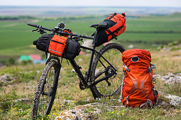 Image showing Bicycle with orange bags for travel