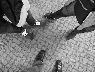 Image showing Three people feet in black and white