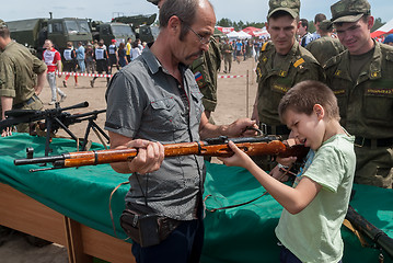 Image showing Boy aims in Mosin\'s rifle