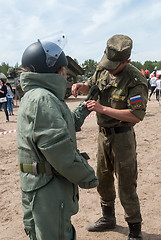 Image showing Girl - visitor of show puts on sapper suit