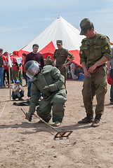 Image showing Visitors of show try on the sapper suit