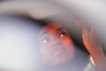 Image showing a young African-American woman makeup in the car