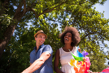 Image showing Young multiethnic couple having a bike ride in nature