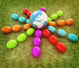 Image showing Colored Easter eggs around Earth on a green grass. 3D illustrati