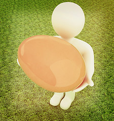 Image showing 3d small person holds the big Easter egg in a hand. 3d image. On