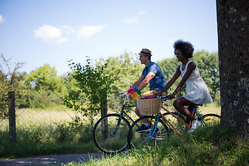 Image showing Young multiethnic couple having a bike ride in nature