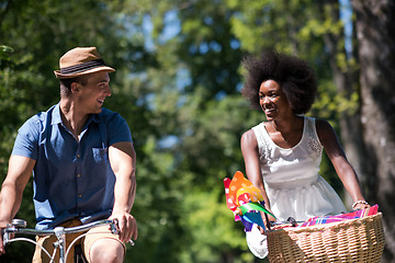 Image showing Young multiethnic couple having a bike ride in nature