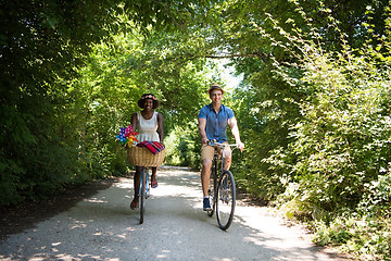 Image showing Young multiethnic couple having a bike ride in nature