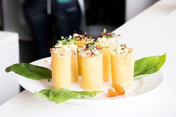 Image showing appetizer - cheese rolls with meat and vegetables