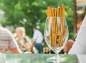 Image showing bread sticks with sesame in a glass