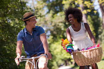 Image showing Young multiethnic couple having a bike ride in nature