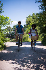 Image showing Young multiethnic couple having a bike ride in nature