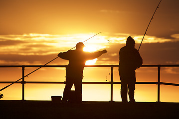 Image showing Fishing men at the beach