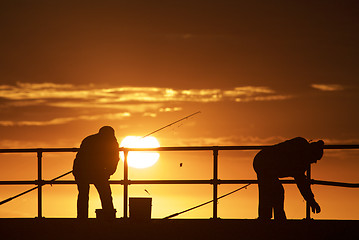 Image showing Fishing men at the beach