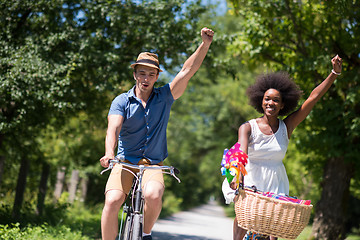 Image showing Young multiethnic couple having a bike ride in nature