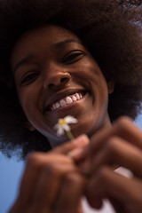 Image showing portrait of African American girl with a flower in her hand