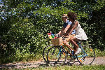 Image showing Young multiethnic couple having a bike ride in nature