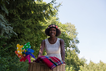 Image showing pretty young african american woman riding a bike in forest