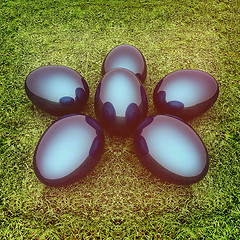 Image showing Metallic blue Easter eggs as a flower on a green grass. 3D illus