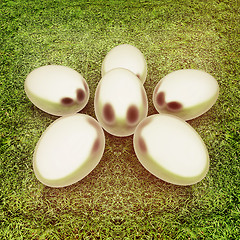Image showing Metall Easter eggs as a flower on a green grass. 3D illustration