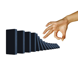 Image showing Hand toppling dominoes