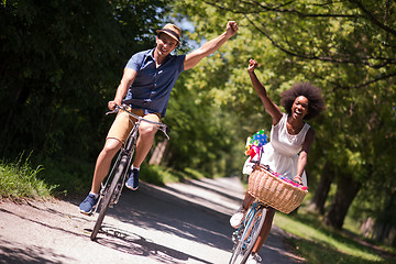 Image showing Young multiethnic couple having a bike ride in nature