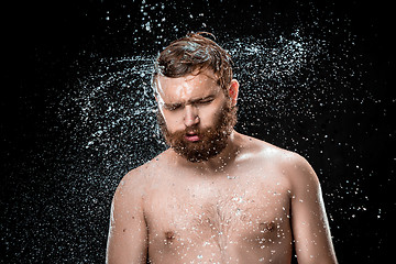 Image showing The water splash on male face