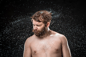 Image showing The water splash on male face