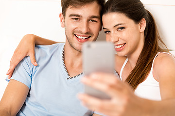 Image showing Couple on bed making selfies