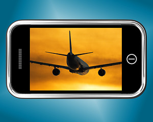 Image showing Airplane Flying Towards The Sunset On Mobile Phone