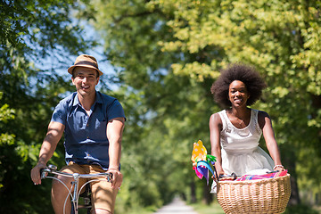 Image showing Young multiethnic couple having a bike ride in nature