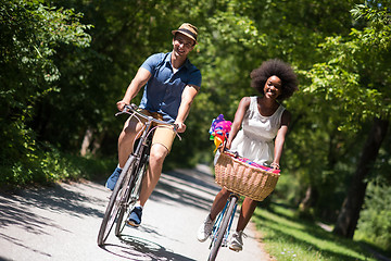 Image showing Young multiethnic couple having a bike ride in nature