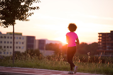 Image showing a young African American woman jogging outdoors