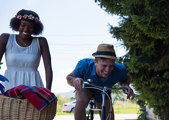 Image showing Young multiethnic couple having a bike ride in nature