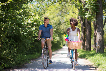 Image showing Young multiethnic couple having a bike ride in nature