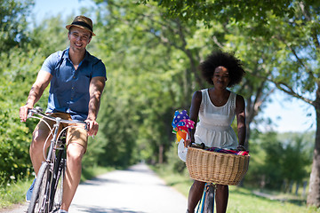 Image showing Young multiethnic couple having a bike ride in nature