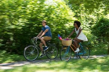 Image showing Young multiethnic couple having a bike ride in nature