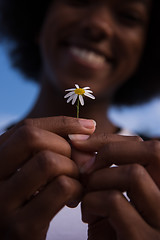 Image showing portrait of African American girl with a flower in her hand