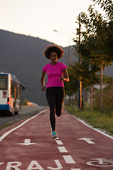 Image showing a young African American woman jogging outdoors