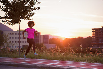 Image showing a young African American woman jogging outdoors