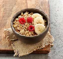 Image showing bowl of granola with banana and raspberries