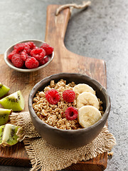 Image showing bowl of granola with banana and raspberries