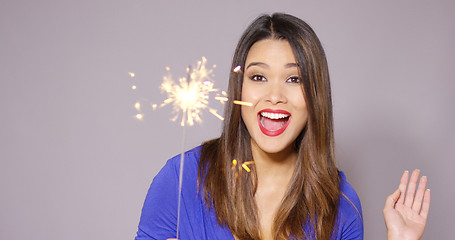 Image showing Beautiful woman holding a burning sparkler