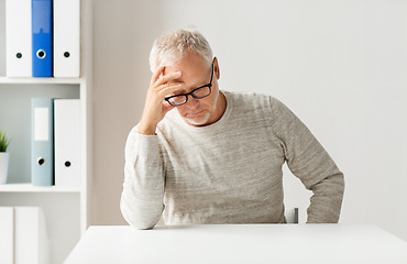 Image showing senior man sitting at table