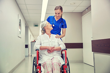 Image showing nurse with senior woman in wheelchair at hospital