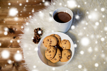 Image showing cups of hot chocolate with cookies on fur rug