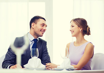 Image showing smiling couple looking at each other at restaurant